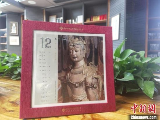 圖為徐晉林制作的敦煌題材的手工書(shū)《走進(jìn)沙漠敦煌——莫高窟與藏書(shū)票藝術(shù)》，深受讀者喜愛(ài)。　閆姣 攝